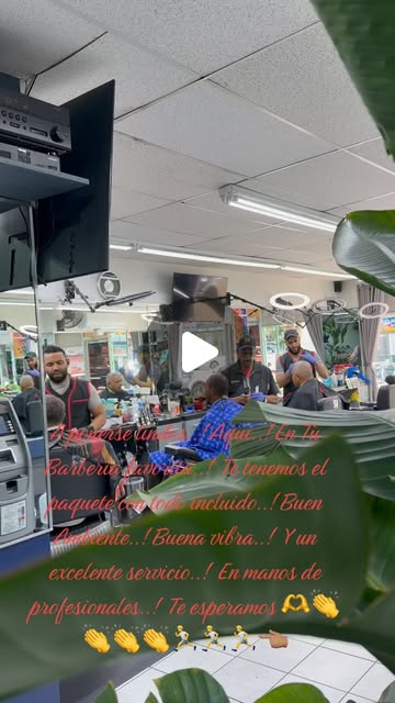 Barber at work inside Batista Barbershop, Bronx NY
